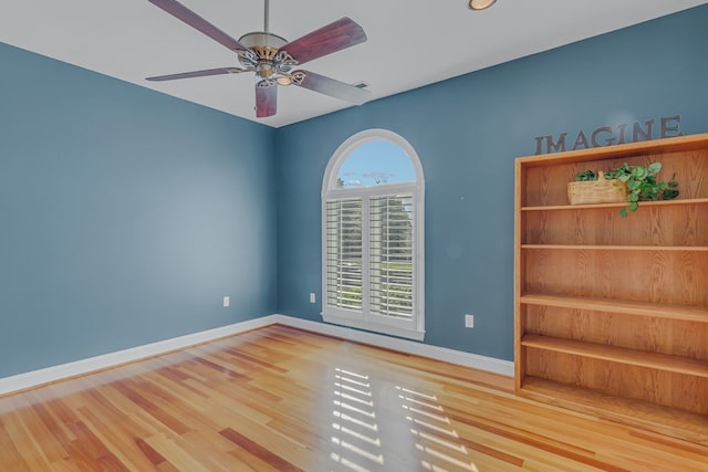 empty room featuring wood-type flooring and ceiling fan