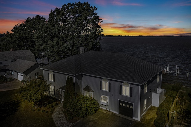 aerial view at dusk with a water view