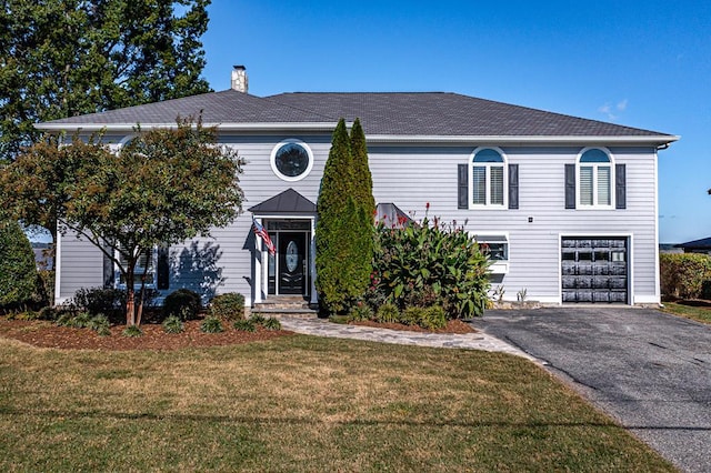 view of front of home with a garage and a front yard