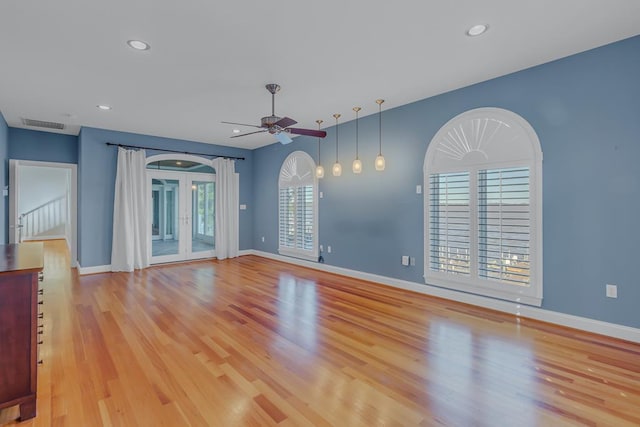 unfurnished living room featuring ceiling fan and light wood-type flooring