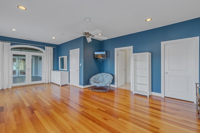 interior space with light hardwood / wood-style flooring, french doors, and ceiling fan