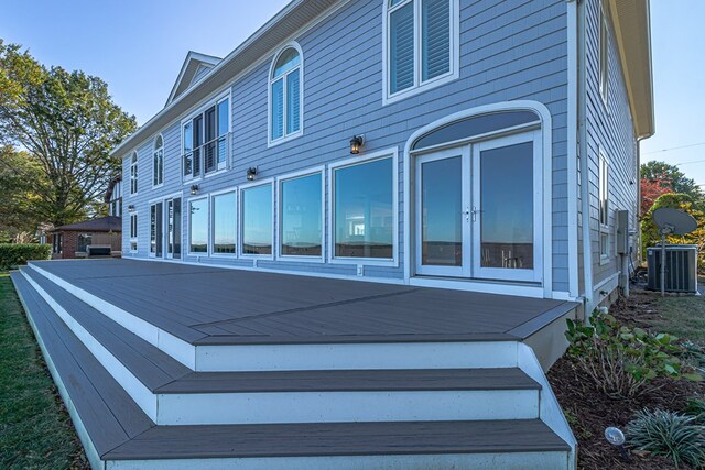 rear view of property with a wooden deck, central AC, and french doors