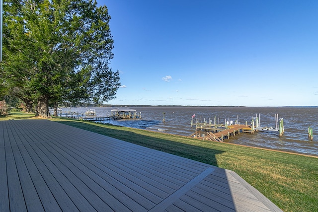 wooden deck with a yard, a boat dock, and a water view