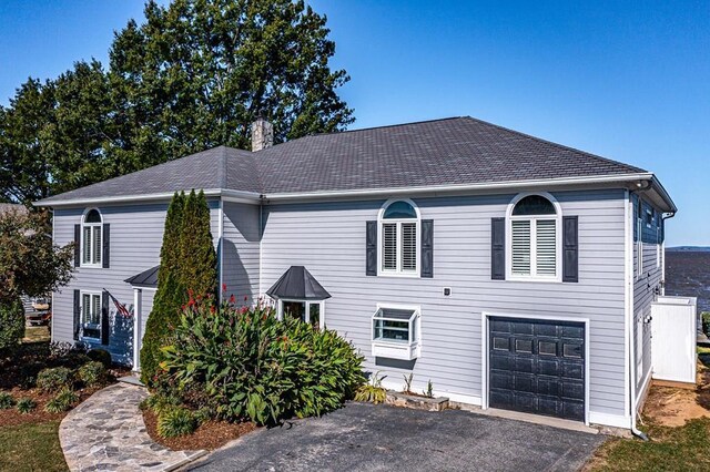 view of front of property with a front lawn and a garage