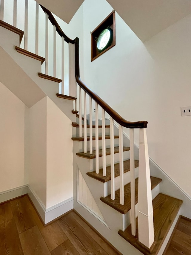 stairs featuring wood-type flooring