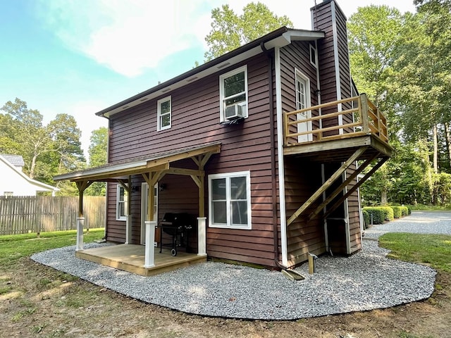 rear view of house with a wooden deck