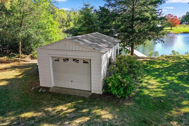 garage featuring a water view and a lawn