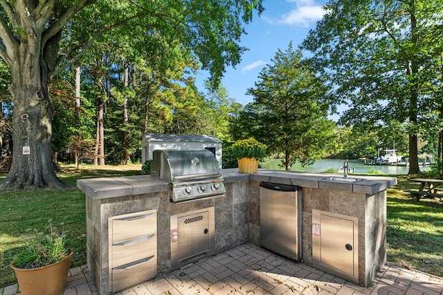 view of patio / terrace with a water view, grilling area, and area for grilling