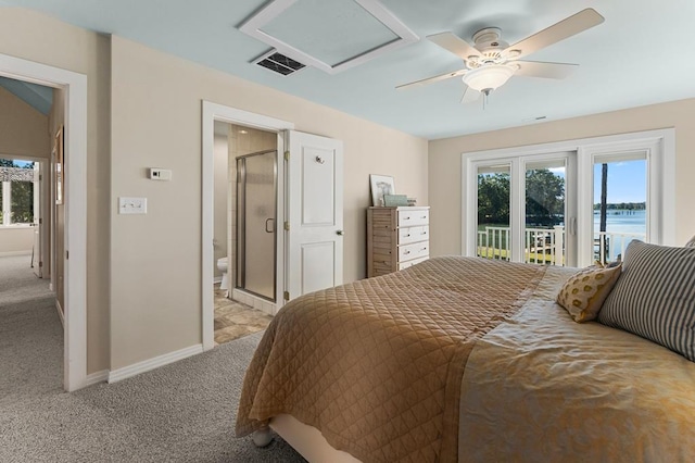 carpeted bedroom featuring ceiling fan, a water view, access to outside, and ensuite bath