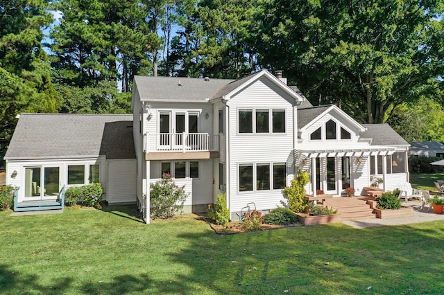 rear view of property with a balcony, a lawn, and a pergola