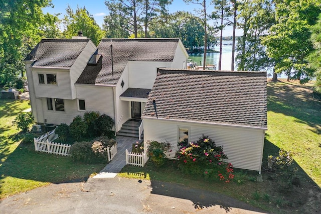 view of front of house featuring a water view and central AC unit