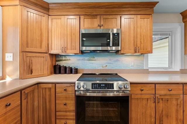 kitchen with appliances with stainless steel finishes and tasteful backsplash