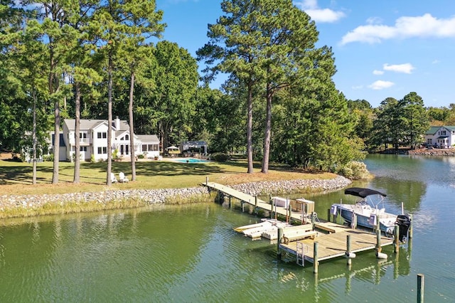 view of dock with a water view and a lawn