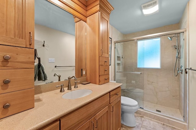 bathroom with toilet, tile patterned flooring, an enclosed shower, and vanity