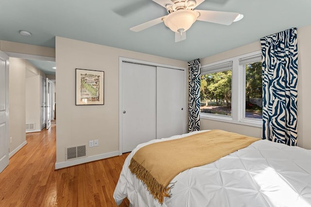 bedroom with ceiling fan, a closet, and light wood-type flooring