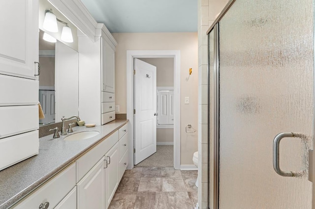 bathroom featuring toilet, walk in shower, tile patterned floors, and vanity