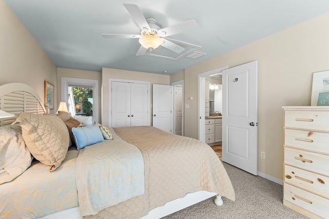 bedroom with ceiling fan, ensuite bathroom, a closet, and light carpet