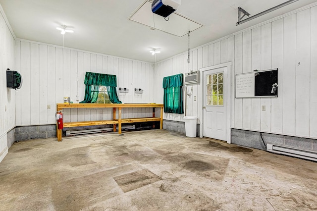garage with a wall unit AC, a workshop area, and a garage door opener