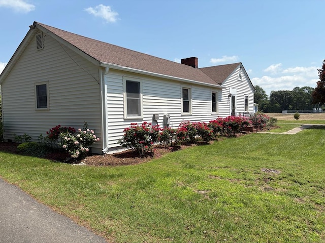 15073 Richmond Rd, Callao, VA 22435 - view of home's exterior featuring a chimney, a yard, and a shingled roof