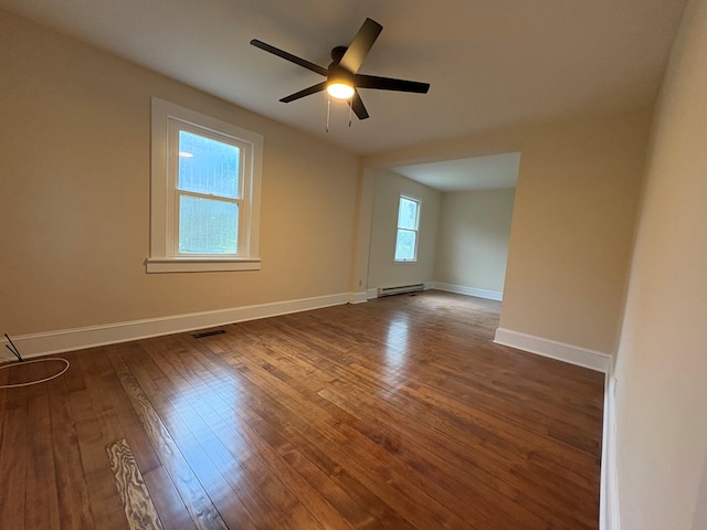 15073 Richmond Rd, Callao, VA 22435 - spare room featuring a baseboard radiator, dark wood finished floors, and a ceiling fan