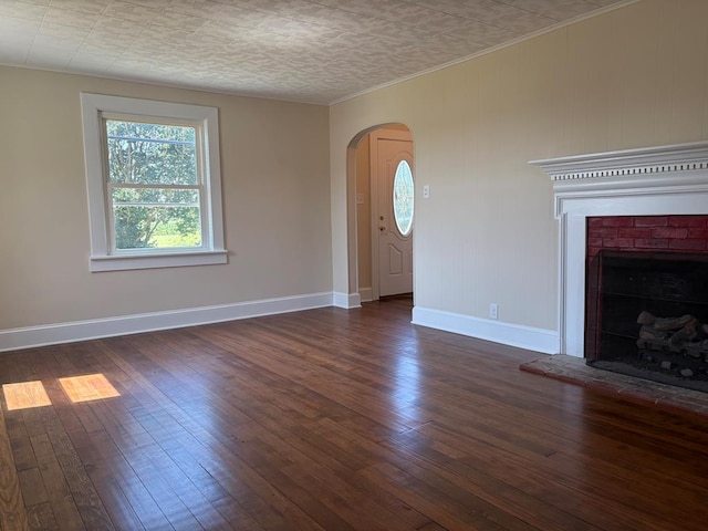 15073 Richmond Rd, Callao, VA 22435 - unfurnished living room featuring healthy amount of natural light, arched walkways, and dark wood-style flooring