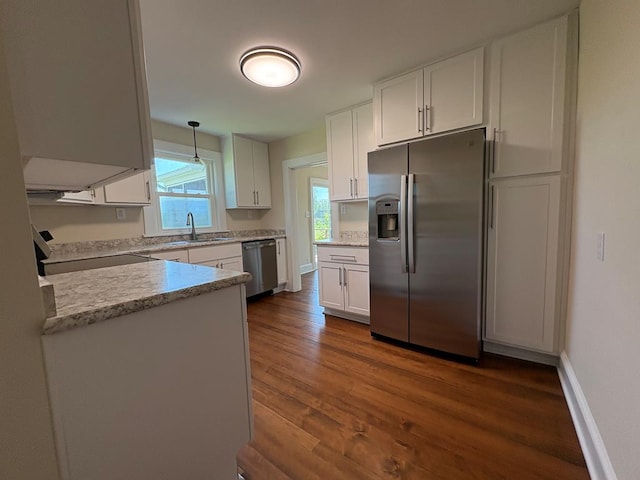 15073 Richmond Rd, Callao, VA 22435 - kitchen featuring stainless steel appliances, white cabinetry, dark wood-style flooring, and decorative light fixtures
