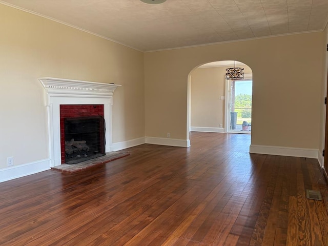 15073 Richmond Rd, Callao, VA 22435 - unfurnished living room featuring arched walkways, dark wood-style floors, a fireplace, and ornamental molding