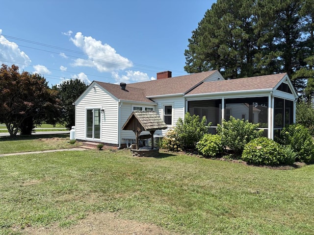 15073 Richmond Rd, Callao, VA 22435 - back of property featuring a sunroom, a chimney, a shingled roof, and a yard
