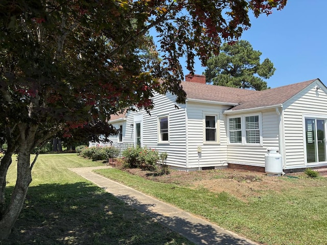 15073 Richmond Rd, Callao, VA 22435 - view of home's exterior featuring a lawn, a chimney, and a shingled roof