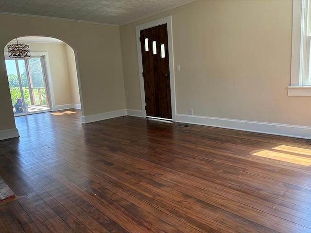 15073 Richmond Rd, Callao, VA 22435 - entryway featuring arched walkways, dark wood-type flooring, and crown molding