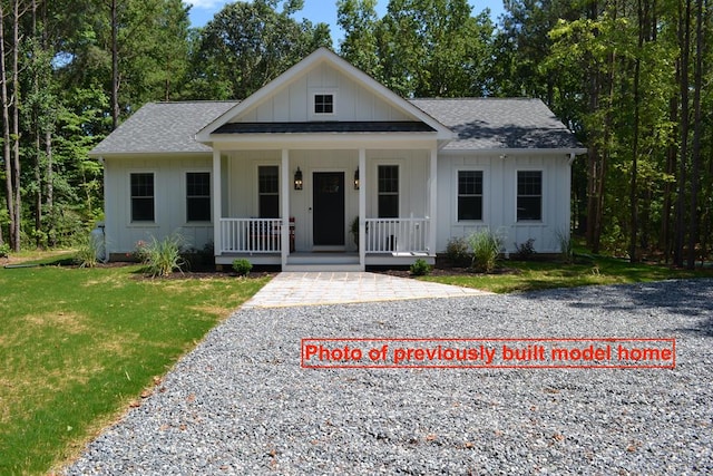 view of front of house with a porch and a front yard