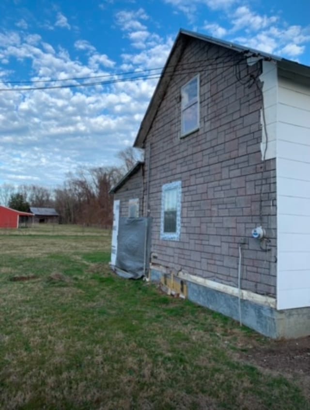 view of home's exterior with a lawn