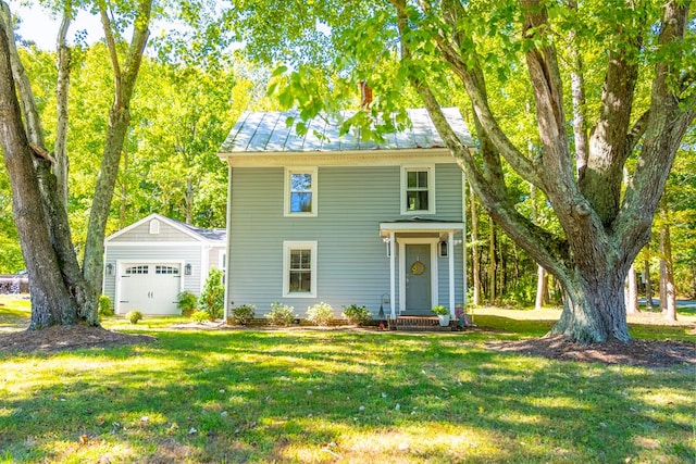 view of front of property with an outbuilding, a front lawn, and a garage