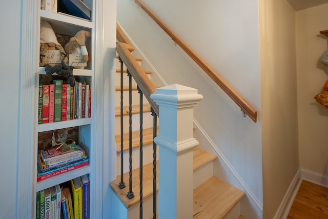 staircase featuring built in shelves