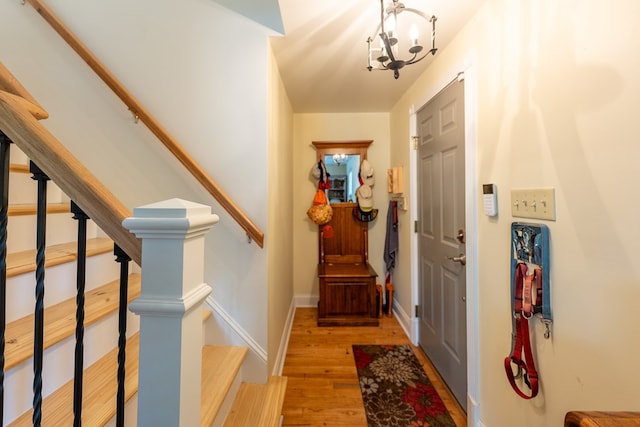 entryway featuring light wood-type flooring and an inviting chandelier