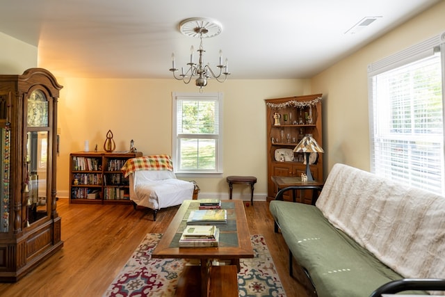 living area featuring a chandelier, hardwood / wood-style flooring, and a wealth of natural light