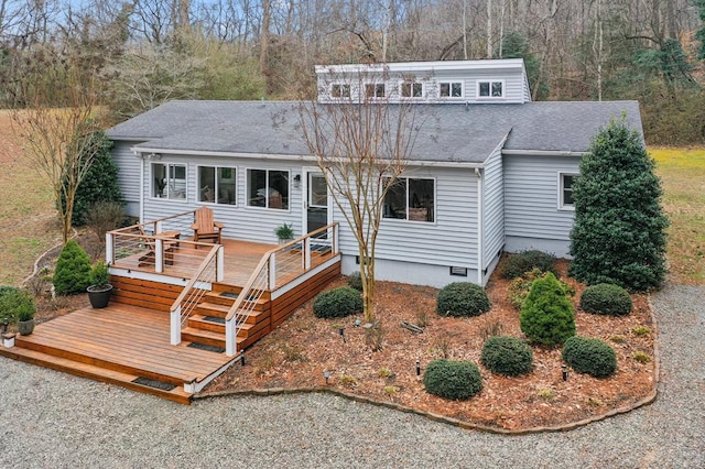 view of front facade with crawl space, roof with shingles, and a wooden deck