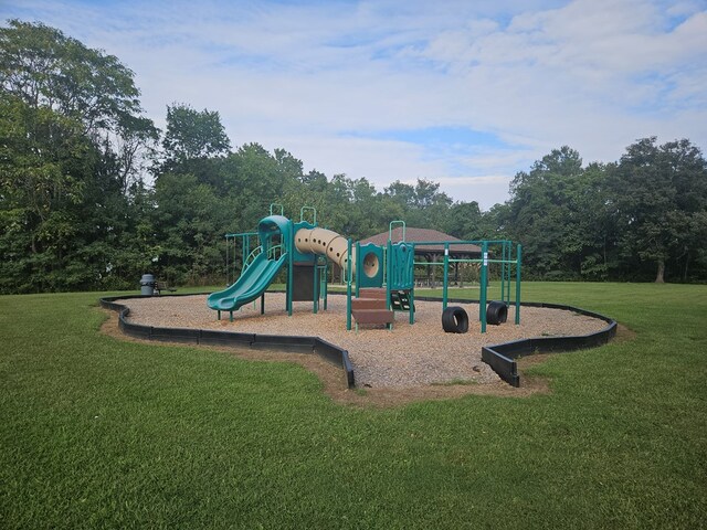 community jungle gym featuring a lawn