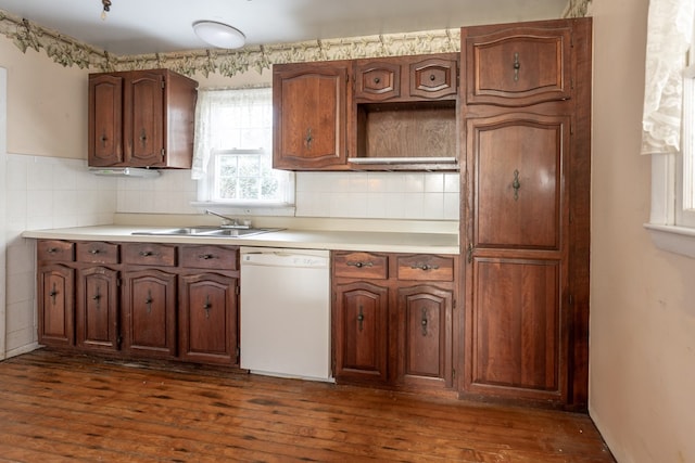 kitchen featuring dark hardwood / wood-style floors, white dishwasher, sink, and decorative backsplash