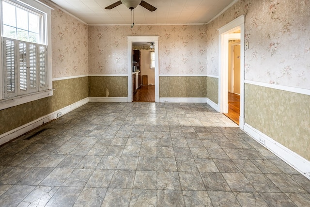 empty room with crown molding and ceiling fan