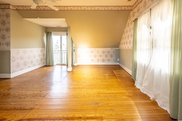 empty room with ceiling fan and light wood-type flooring