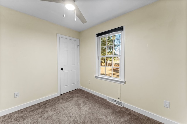 empty room featuring carpet floors and ceiling fan