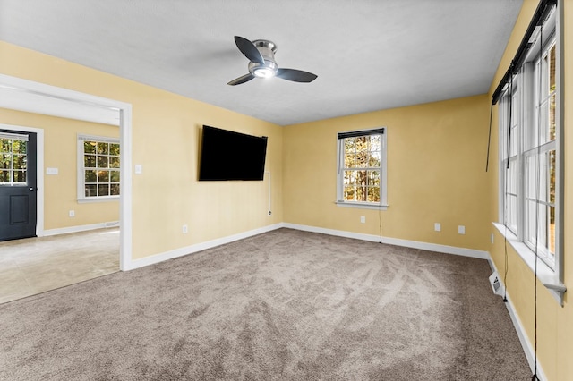 spare room featuring carpet and ceiling fan