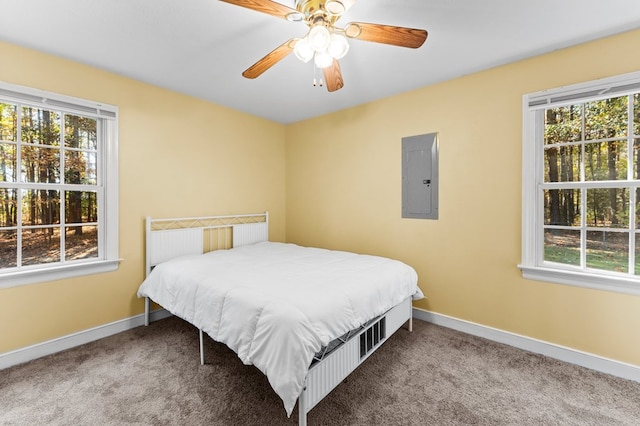 bedroom featuring carpet flooring, ceiling fan, and electric panel