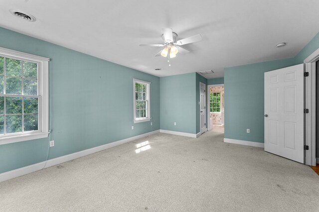 325 Cat Point Dr, Warsaw, VA 22572 - unfurnished bedroom with baseboards, light colored carpet, ensuite bathroom, and a ceiling fan