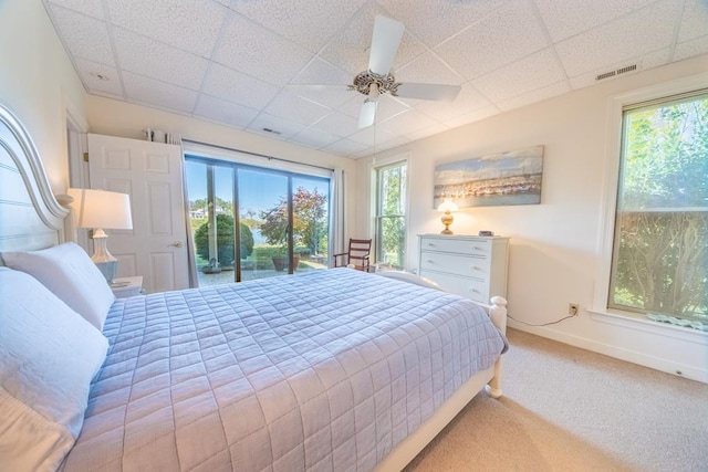 181 Cross St, Urbanna, VA 23175 - bedroom featuring a drop ceiling, carpet floors, multiple windows, a ceiling fan, and access to outside
