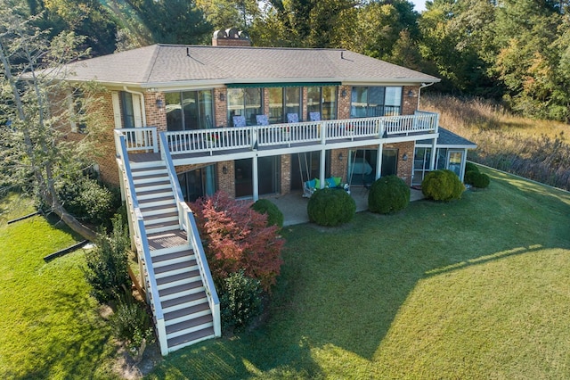 181 Cross St, Urbanna, VA 23175 - rear view of property featuring stairway, brick siding, a yard, and a chimney