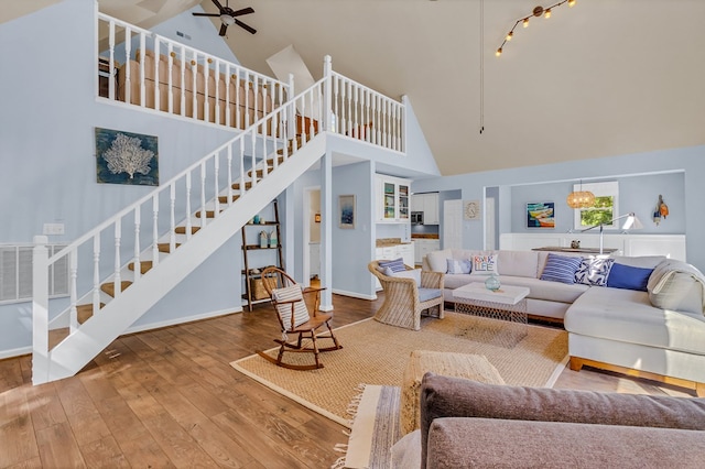 1198 Knights Landing Dr, Heathsville, VA 22473 - living area featuring high vaulted ceiling, stairs, wood-type flooring, ceiling fan, and baseboards