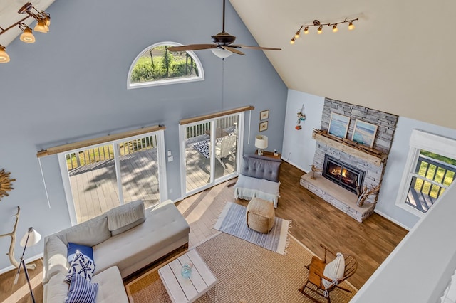 1198 Knights Landing Dr, Heathsville, VA 22473 - living area with high vaulted ceiling, a ceiling fan, a fireplace, and wood finished floors