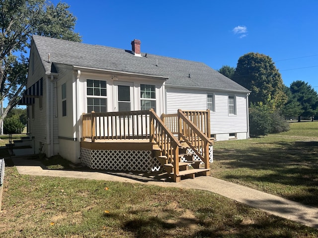 rear view of house featuring a yard